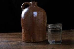 A big jug of moonshine and a jar.