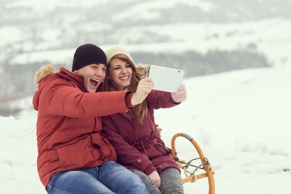 Young couple taking a selfie at one of the top romantic places in Gatlinburg during the winter.