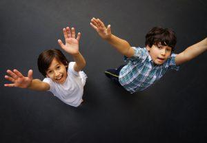 two young boys having fun on trampoline