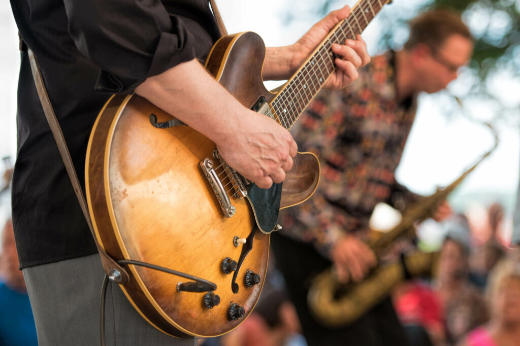 A man is playing acoustic guitar