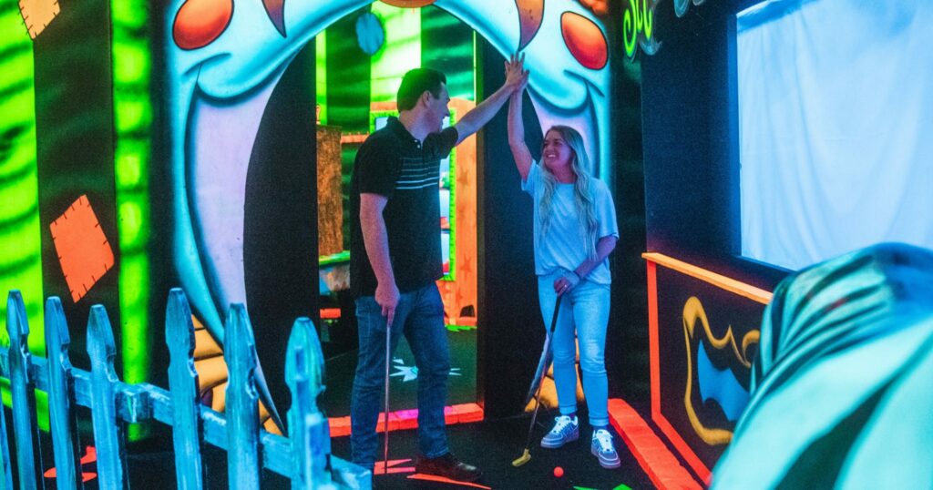 a couple is playing Circus Golf