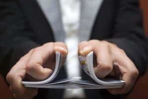 A magician shuffling a deck of cards.