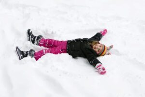 girl making snow angels