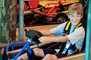 boy riding a go kart