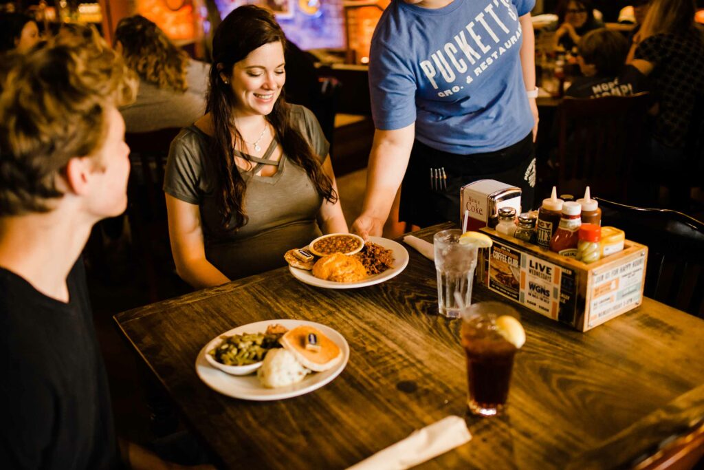 a couple is having dinner at Puckett’s